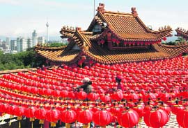 Workers put up decorations made of red lanterns at Thean Hou Temple in Kuala Lumpur on Tuesday. Red decorations are customarily used by Chinese people all over the world to usher in the Lunar New Year on January 26.
