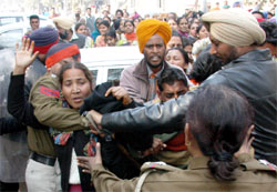 Male police personnel rough up a female teacher of the Employment Guarantee Scheme (EGS) who were trying to gherao the SAD chief Sukhbir Singh Badal at Bathinda