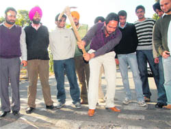 Members of the PUSU try to break speed breakers installed recently at Panjab University on Wednesday.