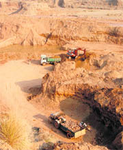 Trucks being loaded with sand and boulders at Khet Purali village in Panchkula.
