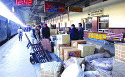 Policemen inspect boxes unloaded from a train at Jalandhar railway station
