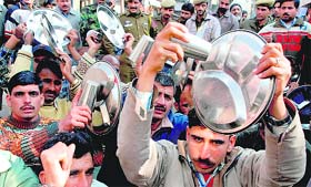 Members of the J&K Home Guards Association stage a demonstration in front of the Divisional Commissioners office in Jammu