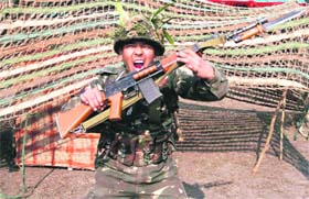 An Army soldier shouts commands during a mock drill as part of Army Day celebrations in Siliguri
