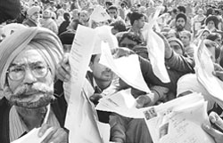 People jostle to get their forms attested from an official during the suvidha camp in Mohali 