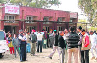 People wait in vain for the Sub-Registrar (East) to return to his office after lunch