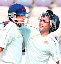 Mumbai's Rohit Sharma (L) congratulates VR Samant after his century against Uttar Pradesh on the 4th day of a Ranji Trophy final match in Hyderabad on Thursday.