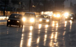 Cars negotiate their way on a Bathinda road as rain lashed the city