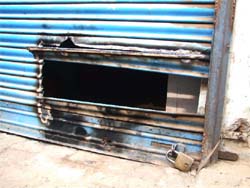 The broken shutter of the shop at Khandsa Road