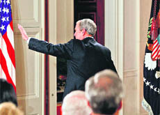 US President George W. Bush waves as he leaves the room after giving a farewell address to the nation, on Thursday in the East Room of the White House in Washington.