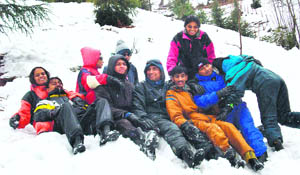 Tourists have fun in snow at Solang, 13 km from Manali, on Saturday.