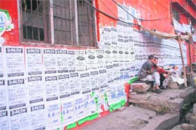 The wall of a building defaced by coaching centres in Jammu