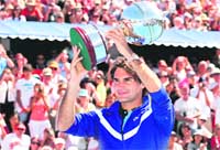 Roger Federer holds the trophy after defeating Stanislas Wawrinka in the final of the invitational Kooyong Classic in Melbourne