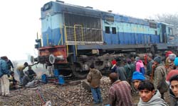 Railway technicians jack up the engine that derailed at Kotfatta near Bathinda on Sunday. 