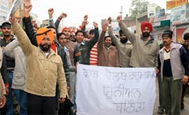 To get their services regularised, members of the Rural Health Pharmacists Union raise slogans against the state government in Bathinda on Sunday. Earlier, they held a protest march through the main markets in the city.