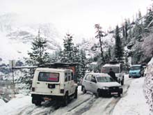 Vehicles caught in snow near Nehru Kund on the Manali-Rohtang road on Sunday afternoon.