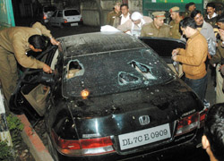 Police officials inspect the car of the gangsters.