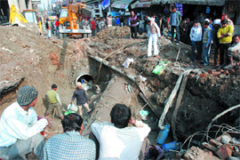 Delhi Jal Board workers repair the water pipe at Vikas Marg, Laxmi Nagar, in New Delhi on Monday which was broken on Sunday.