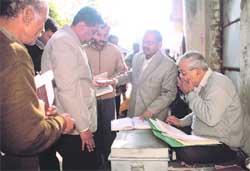 District officials check the records of stamp vendors during a raid conducted at the district collectorate in Dehradun 