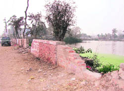 The broken boundary wall of the municipal park in Ambala