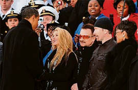 US President-elect Barack Obama talks with singer Shakira, standing beside Bono (centre), at the end of the We Are One concert, one of the events of Obamas inauguration celebrations, at the Lincoln Memorial in Washington.