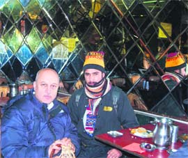 Bollywood actor Anupam Kher holds a Kangri to keep himself warm at a restaurant in Srinagars Lal Chowk on Monday. The actor is here in connection with the shooting of Lamha.