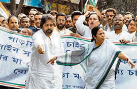 Trinamool Congress chief Mamata Banerjee along with party leader Sudip Bandopadhay (left) and others during a protest seeking a ban on illicit liquor in Kolkata on Monday.