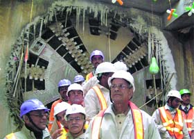 Metro MD E. Sreedharan and other officials in front of the tunnel boring machine after it reached the breakthrough point of the tunnel at Jawaharlal Nehru Stadium in New Delhi