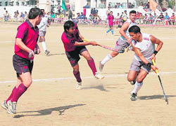 Players vie for the ball during a match at the 77th All-India Swami Shraddhanand  Hockey Tournament in Haridwar on Wednesday.