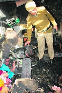A cop inspects the spot at the Paul House where the cylinder burst in Shimla