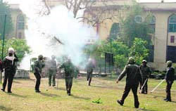 Cops fire tear gas shells to disperse agitated students at Government MMA College in Jammu on Wednesday. 