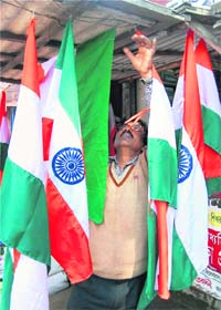Tricolour Joy: A vendor arranges national flags at his shop ahead of the Republic Day in Agartala