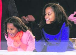 President Barack Obama's daughters Sasha and Malia are all smiles at the inaugural ceremony in Washington. 