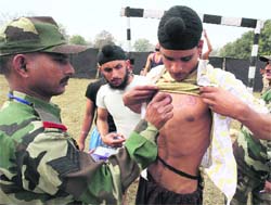 An official makes a mark on the chest of an aspirant at an Army recruitment rally in Sambha district on Thursday.