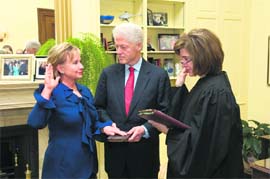 Hillary Rodham Clinton is officially sworn in as the 67th Secretary of State by Judge Kathleen Oberly, Associate Judge, District of Columbia court of Appeals (right), in Washington on Wednesday. Former President Bill Clinton holds the Bible for the swearing-in ceremony.