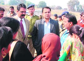 Garhwal Commissioner Umakant Pawar with Haridwar District Magistrate Shailesh Bagoli talk to slum dwellers at Bairagi Camp in Haridwar on Friday.