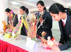 Girls participating in a flower-arrangement contest at Kundan Vidya Mandir in Ludhiana