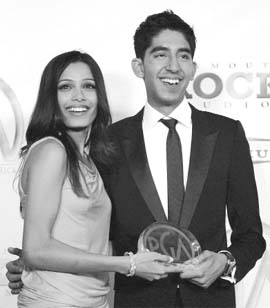 Indian actress Freida Pinto and British actor Dev Patel accept the Darryl F Zanuck Producer of the Year Award in Theatrical Motion Pictures for the movie "Slumdog Millionaire" at the 20th annual Producers Guild Awards in Los Angeles 