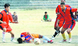 Cantt Blues player slips over while trying to dribble through the Garhwal Sporting defence.