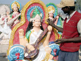 An artiste gives final touches to a statue of Goddess Saraswati in Gurgaon ahead of Saraswati puja.