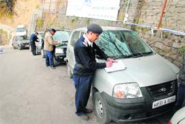 Traffic police challaning vehicles parked on wrong side of the Lakkar Bazaar in Shimla on Thursday.