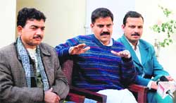 Panthers party leader Harsh Dev Singh, flanked by party MLAs, addresses a press conference at his residence in Jammu 