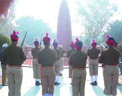 Policemen pay tributes to Mahatma Gandhi on Martyrs' Day at Jallianwala Bagh in Amritsar