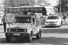 The cavalcade of Punjab Cooperation Minister Capt Kanwaljit Singh escorts a bus carrying councillors before the election of senior vice-president of the Mohali MC on Friday.