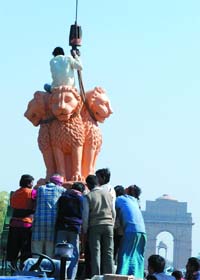 R-Day Gone, Emblem Going: Workers and army jawans remove a replica of the Ashoka Pillar lions from the Rajpath after the R-Day function in in New Delhi