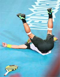 Rafael Nadal of Spain falls to the ground while celebrating victory in his men's singles semi-final match against compatriot Fernando Verdasco on Friday.