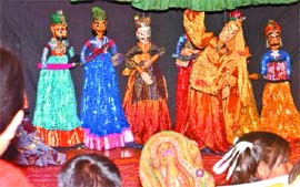 Visitors watch a puppet show at Oxford Book Store in New Delhi on Saturday.