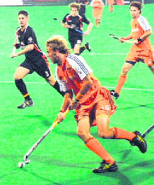 Netherlands Evers tries to dodge German players during the Punjab Gold Cup Hockey Tournament in Chandigarh on Saturday.