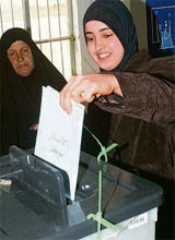 A resident casts her vote at a polling station in Ramadi, 100 km west of Baghdad, on Saturday. Iraqis voted behind barbed wire and rings of police in an election that tested the war-battered countrys fragile security gains.