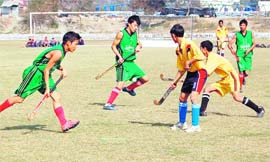 Players in action during the final of the u-18 hockey tournament in Dehradun on Sunday. A Tribune photograph