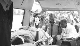 Paramedics at the Wilson airport in Nairobi attend to a man burnt after an oil truck crashed and burst into fire near the Rift Valley town of Molo on Sunday. 